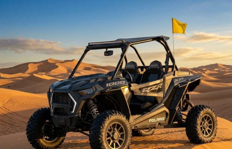 Polaris RZR XP 1000cc off-road vehicle in Dubai desert at sunset.