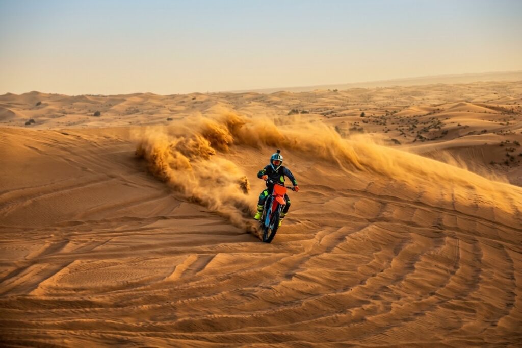 A KTM rider exploring the desert dunes